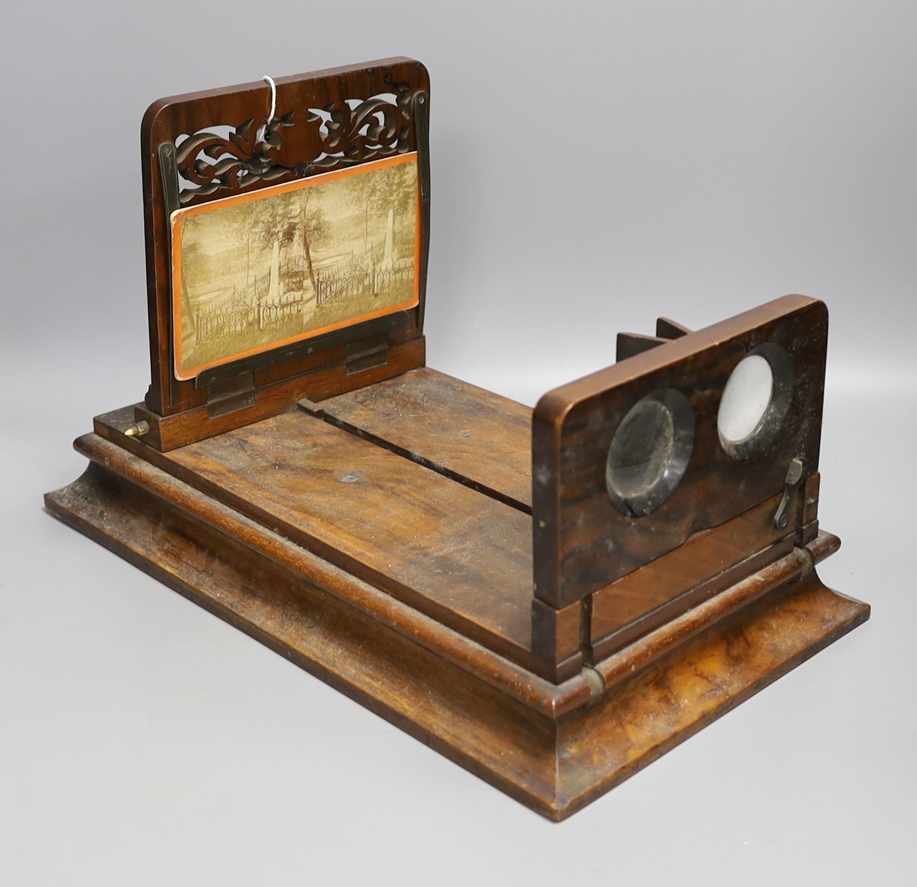 A Victorian walnut stereoscopic viewer and slides, a tinplate viewer, cigarette cards, Glamour Girls, etc.